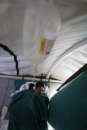 Rio de Janeiro, Brazil: A man diagnosed with dengue fever receives medical attention