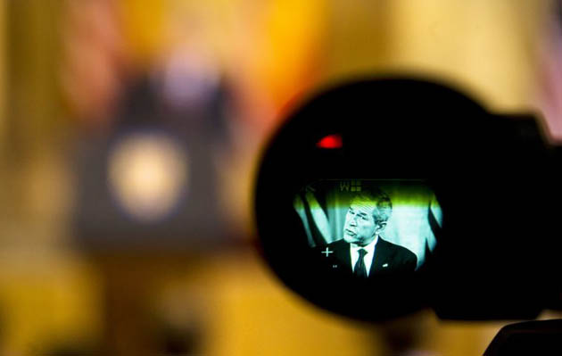 Bucharest, Romania: George Bush, seen through the view finder of a video camera, delivers a speech on the first day of the NATO summit