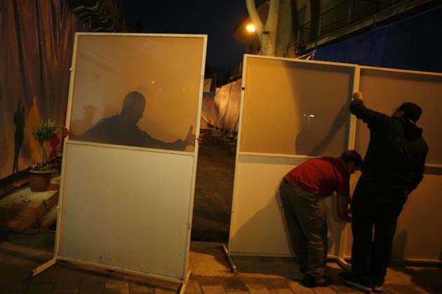 Workers remove a barrier