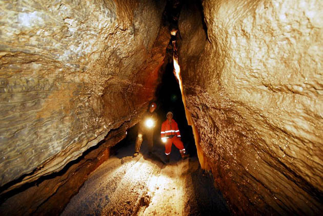 Mausendorf, Germany: Tunnelling construction workers and speleologists examine a dripstone cave