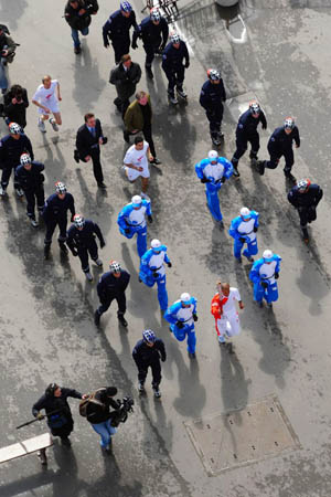 Paris, France: Stephane Diagana begins to run with the Beijing Olympics flame for the first relay starting from the Eiffel tower