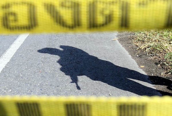 Yala province, Thailand: Forensic experts examine a site of a roadside bomb blast in which two rangers were injured