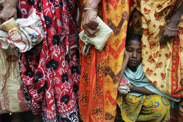 Dhaka, Bangladesh: People queue for their allotted 5 kgs of rice