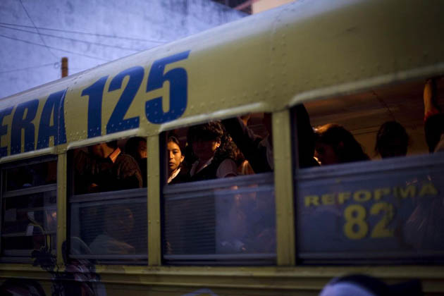 A woman looks out from a public bus in Guatemale City