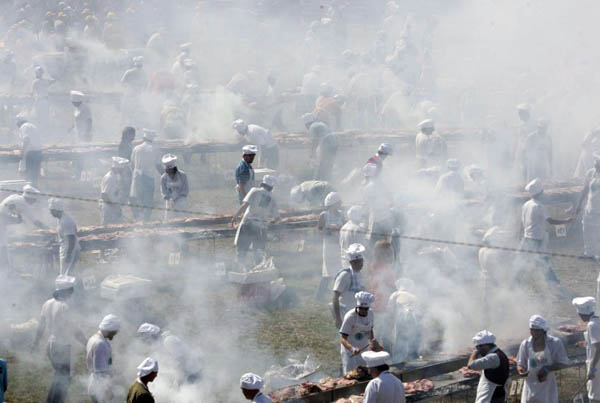 Montevideo, Uraguay: Cooks barbecue meat in an attempt to break a record for the world's largest barbecue