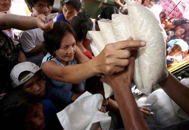 Filipinos buy government-controlled rice sold from a roving truck