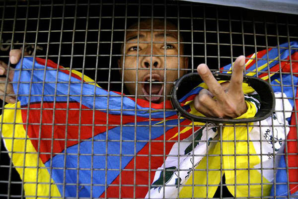 Katmandu, Nepal: An arrested Tibetan shouts slogans from inside a police van during a demonstration outside the Chinese consulate