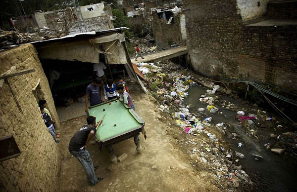 Islamabad, Pakistan: Pakistani boys play billiards in the Christian neighbourhood of Khashi Kaluni