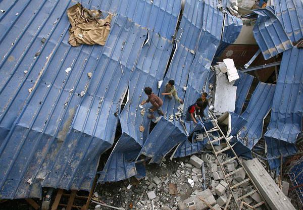 Gaza City, Gaza Strip: Palestinian children climb the destroyed roof of a mosque in the Shujaiya neighbourhood