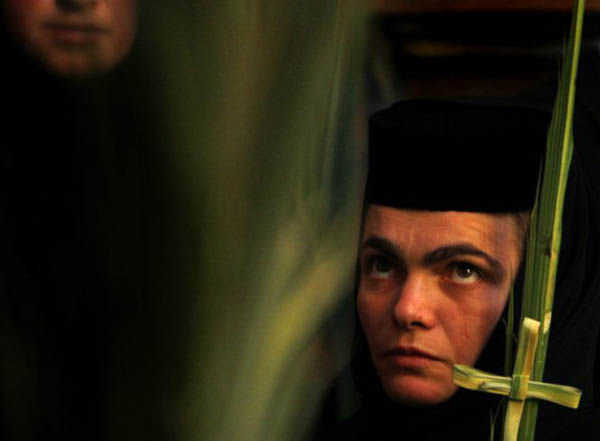 Old City, Jerusalem: An Orthodox nun holds a palm frond during the Greek Orthodox Palm Sunday mass at the Church of the Holy Sepulcher
