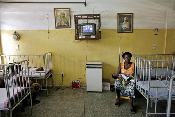 Accra, Ghana: A woman sits with her child in the Princess Marie Louise children's hospital