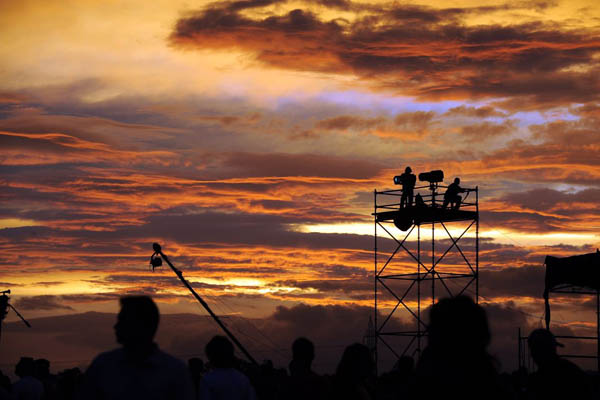 Alajuela, Costa Rica: Light technicians at sunset during the second day of Imperial Festival at the La Guacima race track