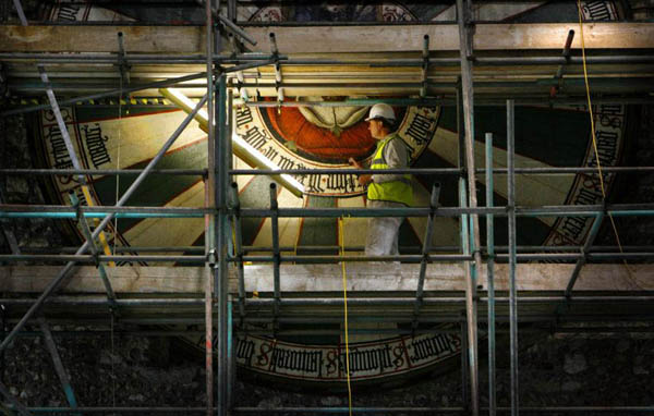 Winchester, UK: Conservator Peter Austen carries out the finishing touches of his restoration of King Arthur's famous Round Table in Winchester's Great Hall