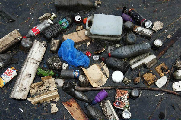 London, UK: Rubbish floats on the river Lea near Hackney Marsh