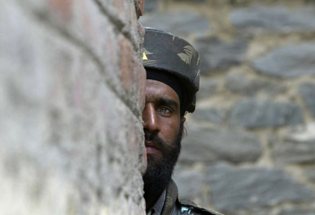 An Indian Army soldier looks on during a gun battle in Baramulla