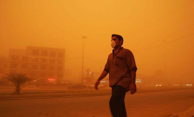 A man walking in a sandstorm in Baghdad