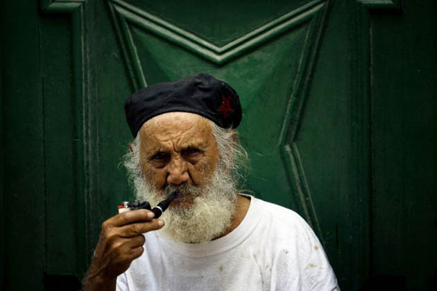 Reinaldo sits and smokes a pipe in Havana