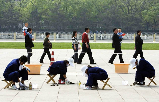 Chinese workers clean up Tiananmen Square ahead of the May Day holidays