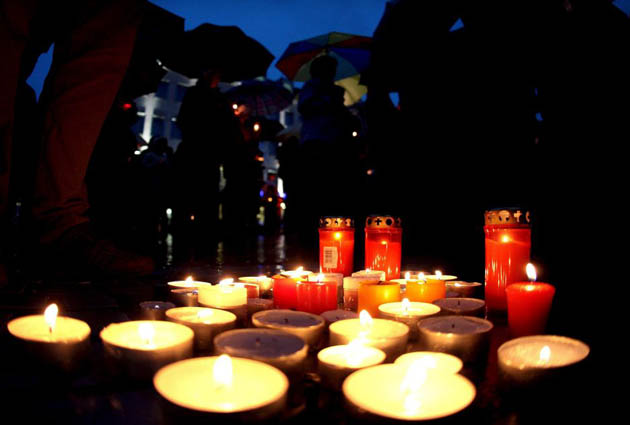 Residents of Amstetten gather for a candle-lit vigil in the town square f