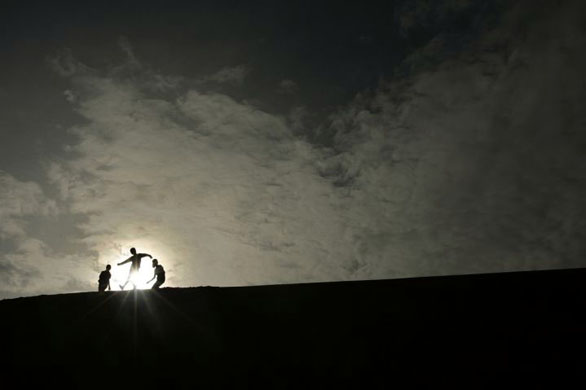 Gaotai, China: Children play in the desert during dusk