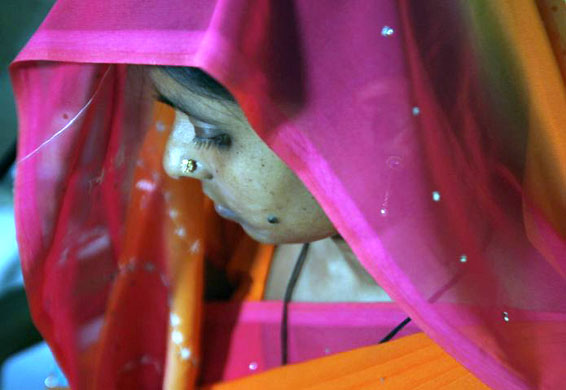 Siliguri, India: A woman suffering from HIV/AIDS waits to receive the vaccine 'Pneumovax'