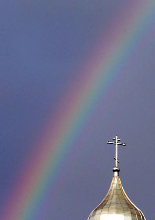 Logoisk, Belarus: A rainbow over an Orthodox church