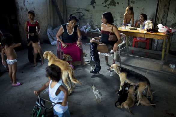 San Pedro Sula, Honduras: Deborah, centre right, a transvestite who tested positive for HIV three years ago, talks to sex worker Dona Pastora