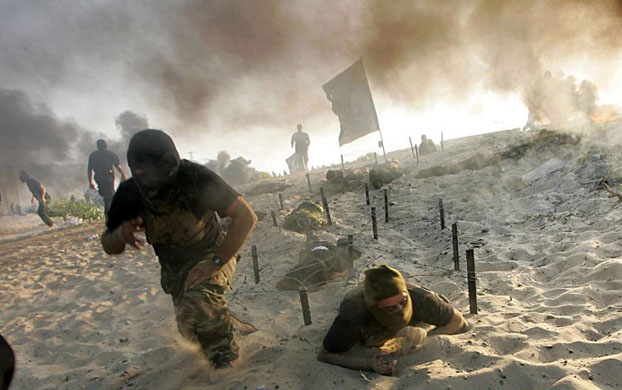 Gaza City, Gaza Strip: Fighters from the Hamas-affiliated Popular Resistance Committees practice their skills during a military graduation ceremony