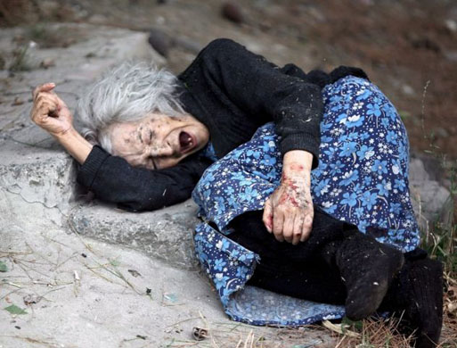 Georgian elderly wounded woman cries after the bomb attack of Russian warplanes on Gori