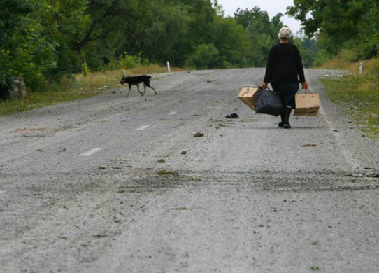 A local woman leaves her village after fighting in South Ossetia 
