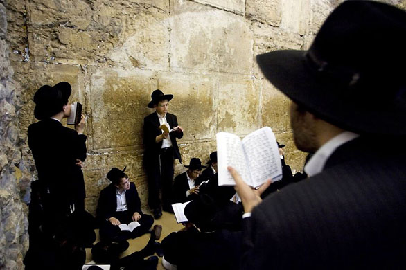 Jerusalem: Ultra-orthodox Jewish men pray as they gather for the mourning ritual of Tisha B'Av at the Western Wall