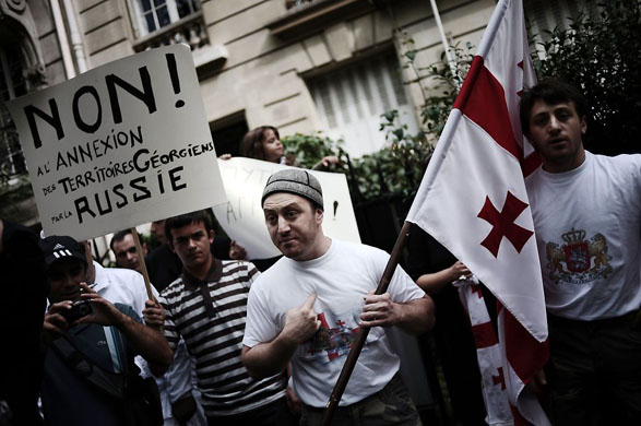 Paris, France: Georgians hold flags and placards reading 'no to the annexation of Georgian territories by Russia' during a demonstration in front of the Russian embassy