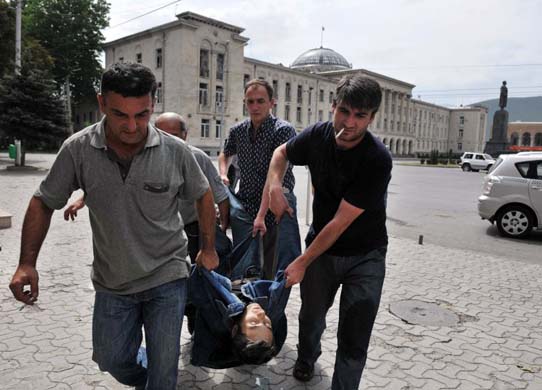 A dead man is carried from the central square in Gori