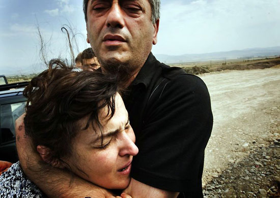 South Ossetia: A displaced woman from Gori breaks down in tears while fleeing the region