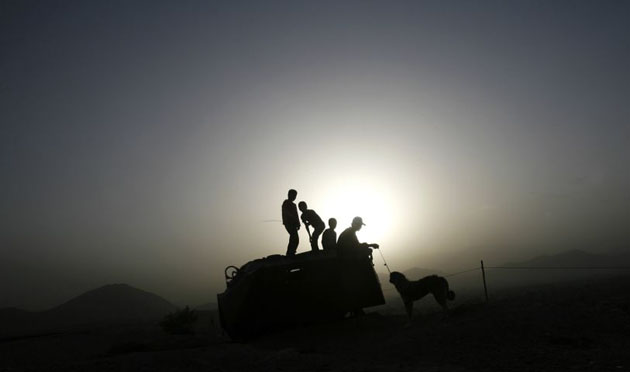 Kabul, Afghanistan: Children sit on an abandoned armoured personnel carrier