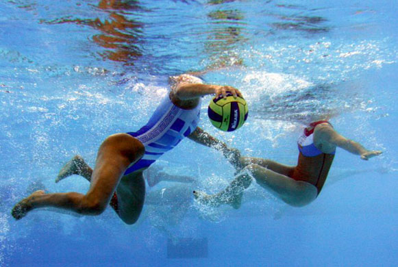 Beijing, China: Greek and Dutch players compete during a preliminary women's water polo match