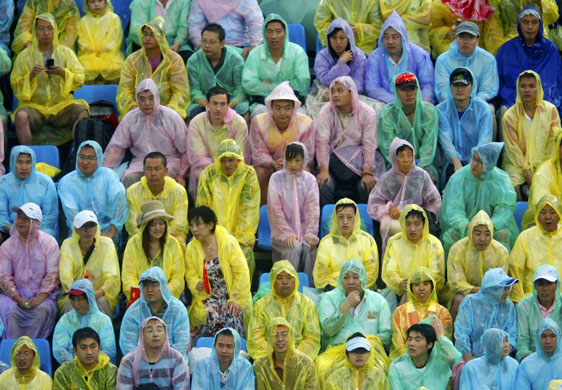 beijing olympic spectators in the rain 