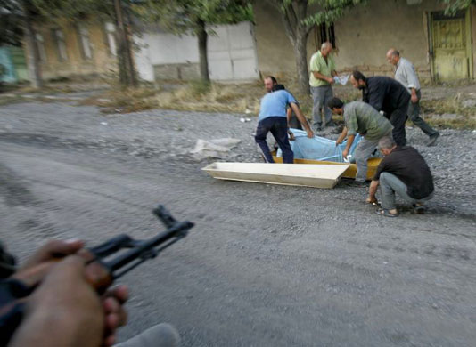 Tskhinvali, South Ossetia: Local men collect the body of a Georgian soldier for burial