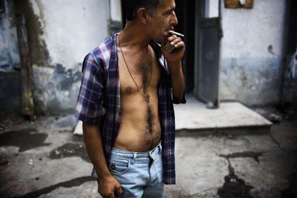 Tbilisi, Georgia: A key for a temporary room hangs from the neck of a refugee at a Soviet era military hospital