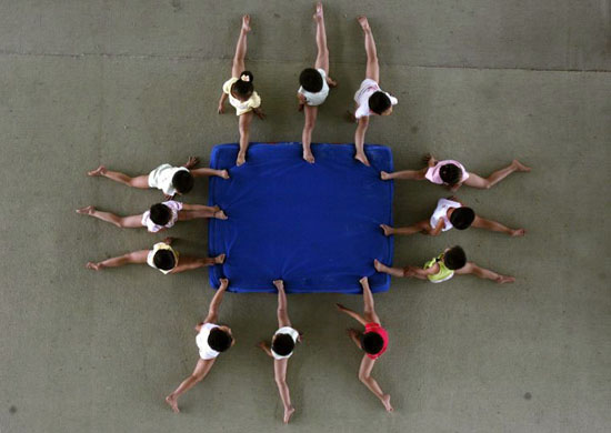 Xiantao, China: Children stretch at the Li Xiaoshuang Gymnastics School