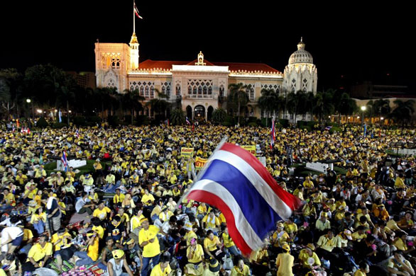 Bangkok, Thailand: Anti-government protestors swarm around Government House