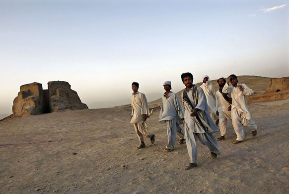 Kabul, Afghanistan: A group of men head home after a day's work