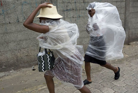 Port-au-Prince, Haiti: People protect themselves from rain caused by hurricane Gustav