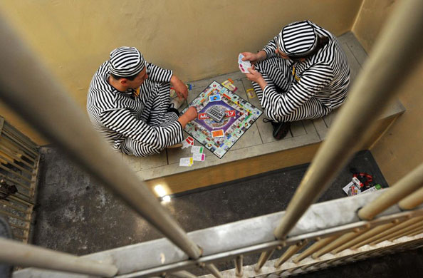 Frankfurt, Germany: Marcel Pozgay and Christian Michael sit in a cell of the former 'Klapperfeldstrasse Custody' and play Monopoly as they take part in a world record attempt