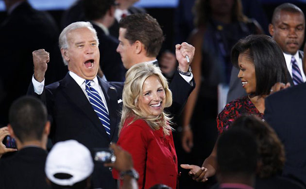 Democratic vice presidential nominee Joe Biden cheers as he stands with his wife Jill and Michelle Obama at the Democratic national convention in Denver