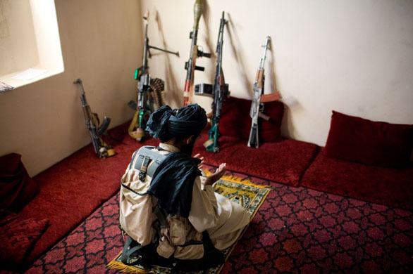 A Taliban insurgent prays in Wardak