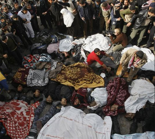 Palestinians look at bodies removed from the sites of Israeli air strikes in Gaza City on December 27, 2008. At least 155 Palestinians were killed across the Gaza Strip today in massive Israeli air strikes on the Hamas-run enclave, Hamas radio reported. Israeli military spokesman Avi Benayahu told army radio the massive bombardment of Gaza was only just beginning.