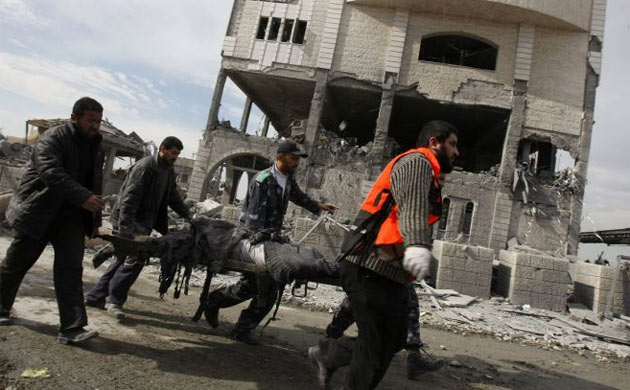 Palestinians carry a body after removing it from the site of an Israeli air strike in Gaza City on December 27, 2008. At least 155 Palestinians were killed across the Gaza Strip today in massive Israeli air strikes on the Hamas-run enclave, Hamas radio reported. Israeli military spokesman Avi Benayahu told army radio the massive bombardment of Gaza was only just beginning.