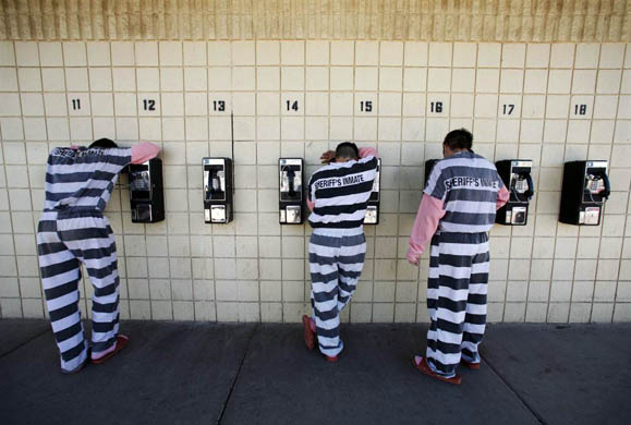 Inmates talk on pay phones Tent City jail