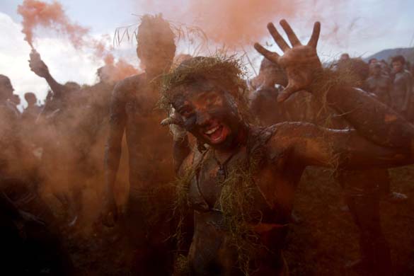 Revellers covered in mud at the Bloco de Lama parade in Parati, Brazil